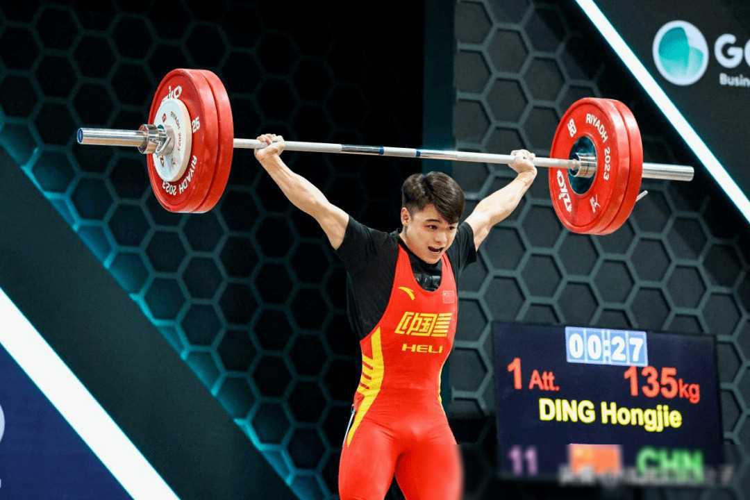 举重比赛进行中，运动员尽力争取领先地位